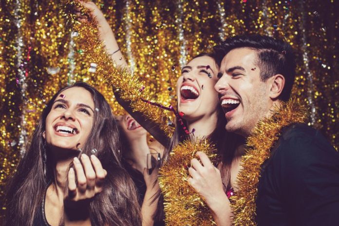 people celebrating new years eve party 2021